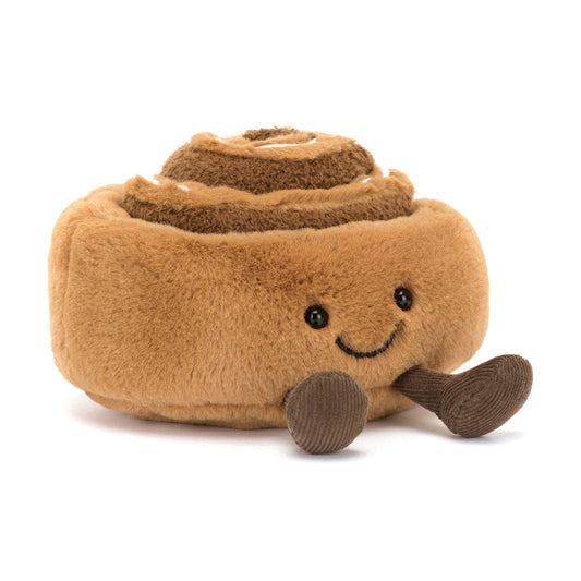 Jellycat bamse, som forestiller en kanelsnegl med et smilende ansigt og små ben.