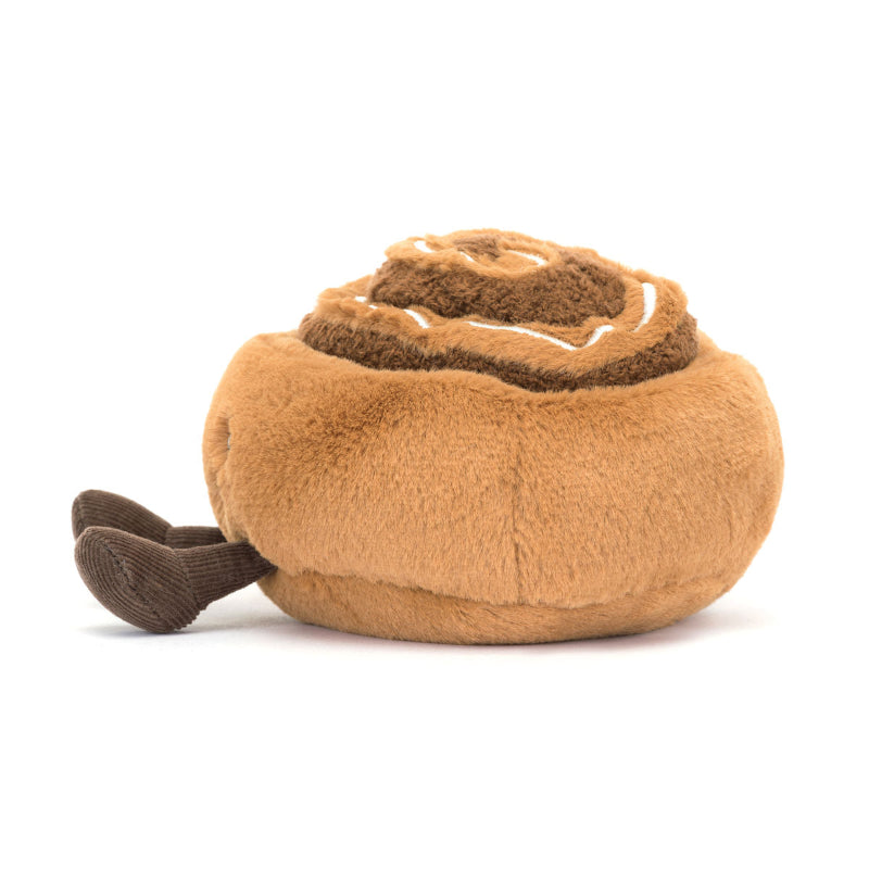 Jellycat bamse, som forestiller en kanelsnegl med et smilende ansigt og små ben.
