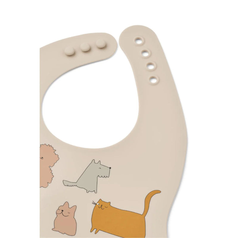 Cremefarvet silikone hagesmække med katte og hunde.
