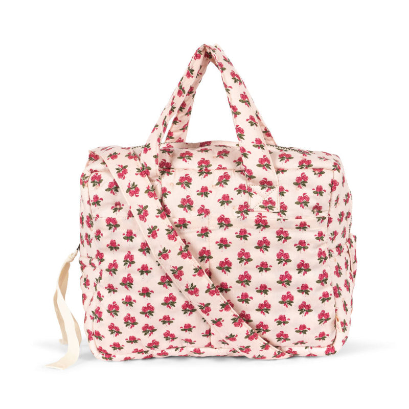 Pusletaske til dukke med blomster.