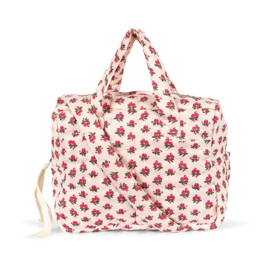 Pusletaske til dukke med blomster.